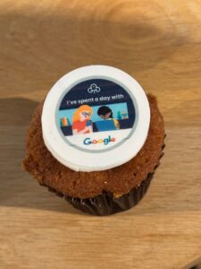 a cupcake with a google guiding badge on it