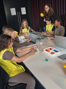Brownies work on lego projects at a table